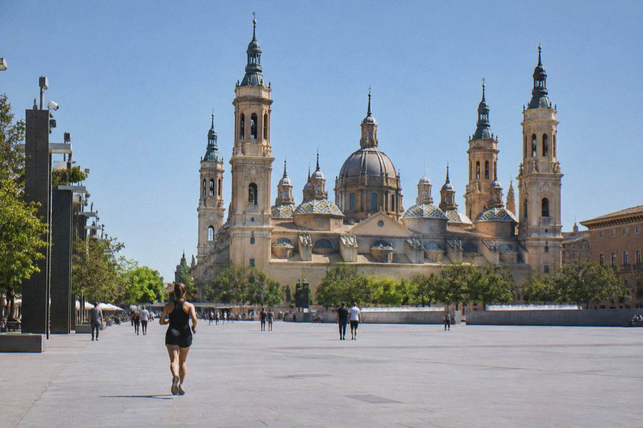 The domes and towers of the Basílica del Pilar rising above Plaza del Pilar in Zaragoza under a clear sky
