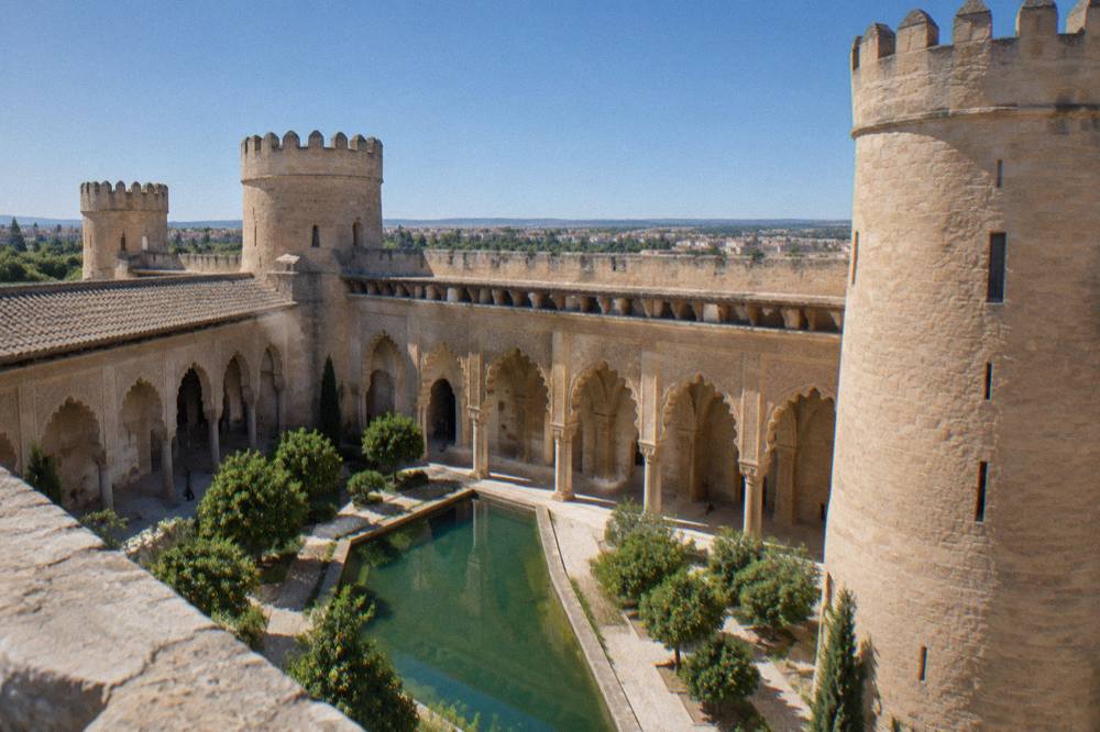 Carved plaster arches around the central courtyard of the Aljafería Palace