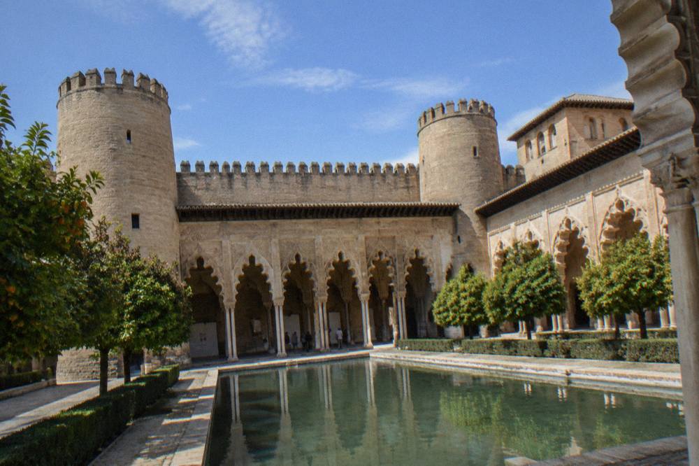 The Aljaferia palace courtyard with its carved Islamic arches in Zaragoza