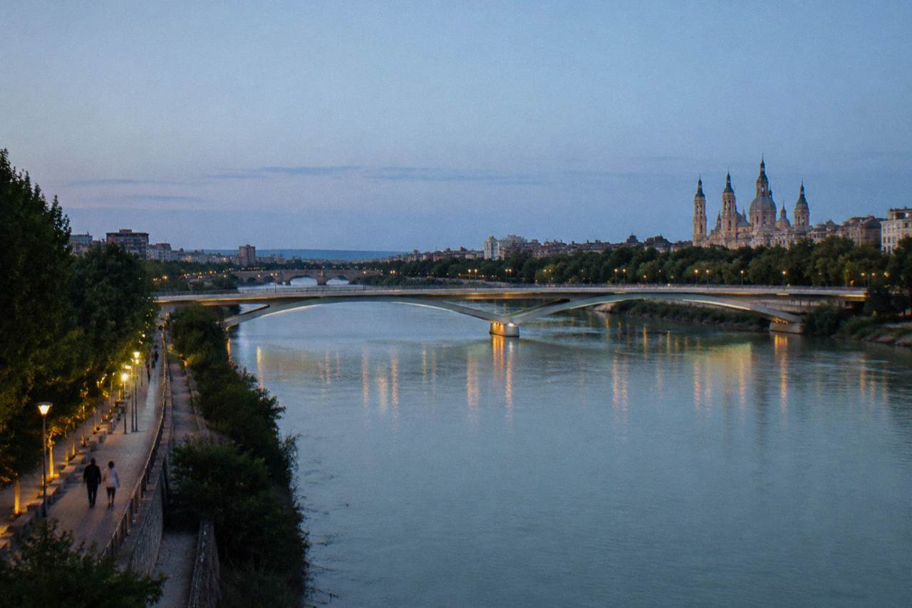 Wide view of modern bridges crossing the Ebro river in Zaragoza at dusk