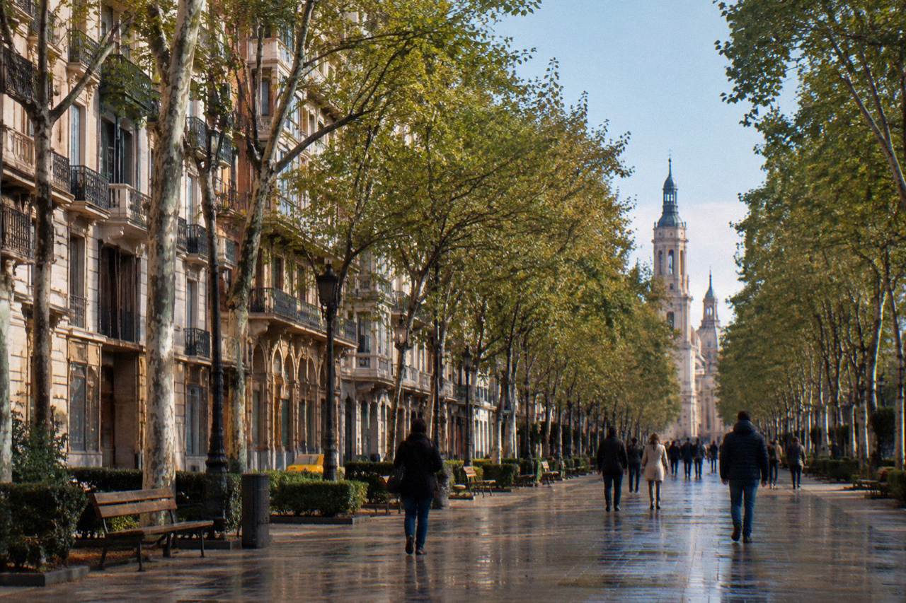 The tree-lined Paseo de la Independencia in Zaragoza with pedestrians walking along the wide pavement