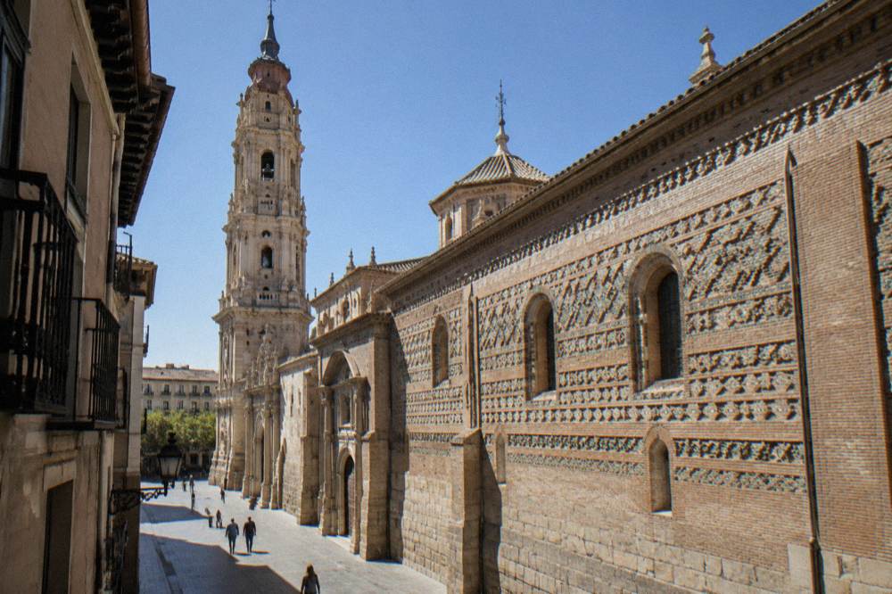 La Seo cathedral facade in Zaragoza seen from a narrow old town street