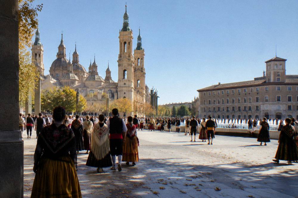 Crowds in traditional Aragonese dress filling a Zaragoza street during the Fiestas del Pilar