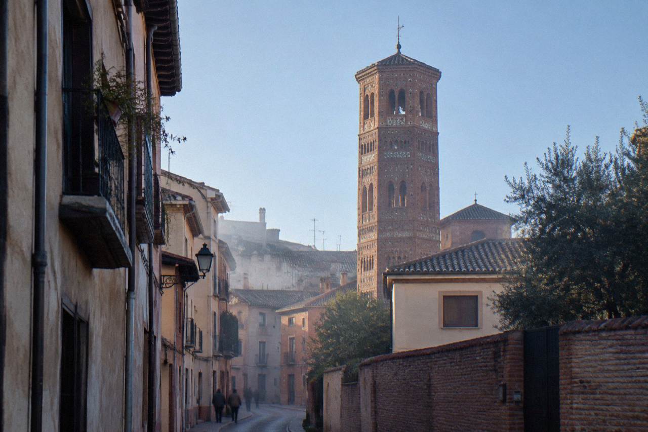A brick church tower rising over narrow streets in the San Pablo quarter of Zaragoza