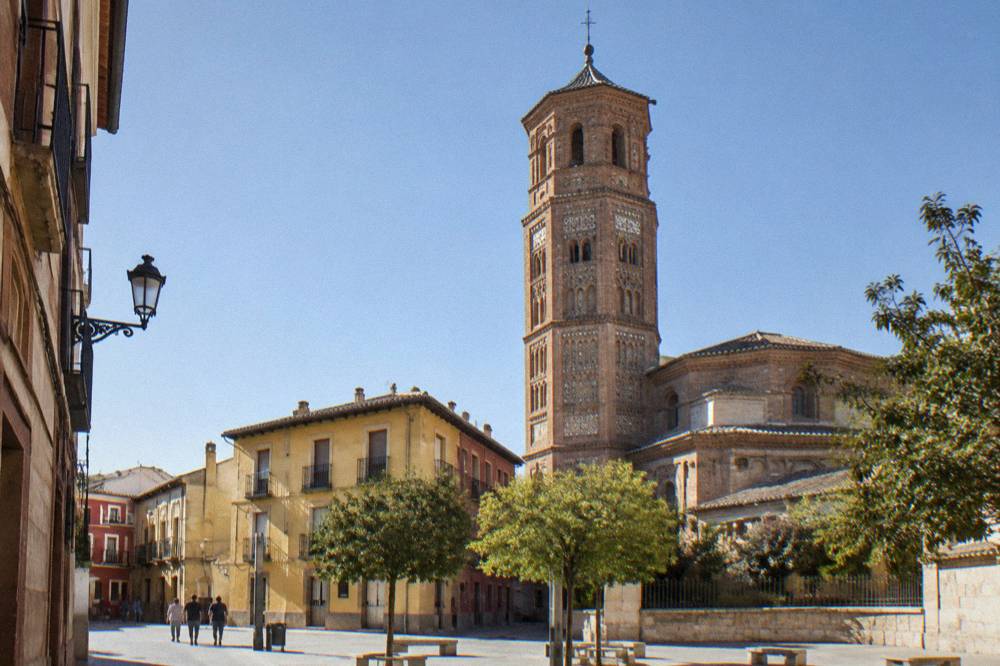 The brick tower of the San Pablo church seen from a small square in Zaragoza