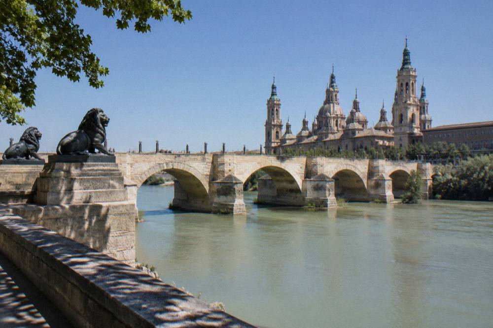 The stone arches of the Puente de Piedra bridge over the Ebro river in Zaragoza