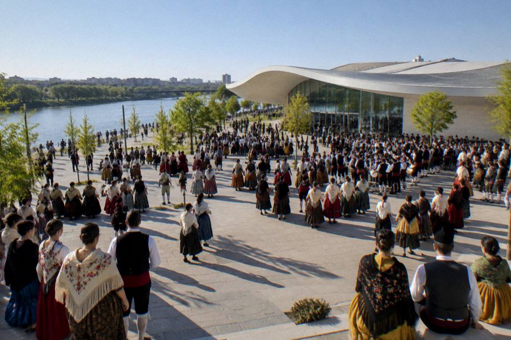 Crowds in traditional Aragonese dress filling a wide city plaza during a festival