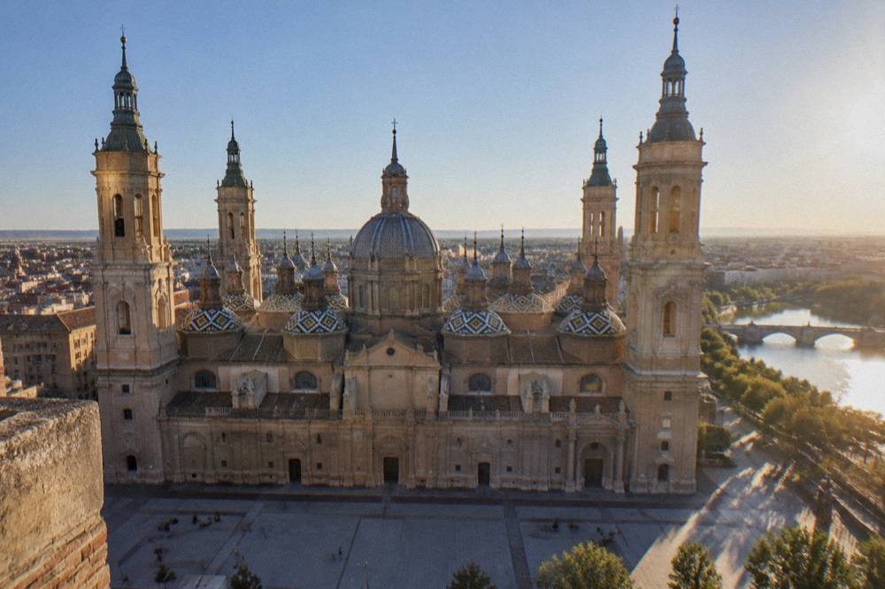 The tiled domes of the Basilica del Pilar seen at eye level from a high tower