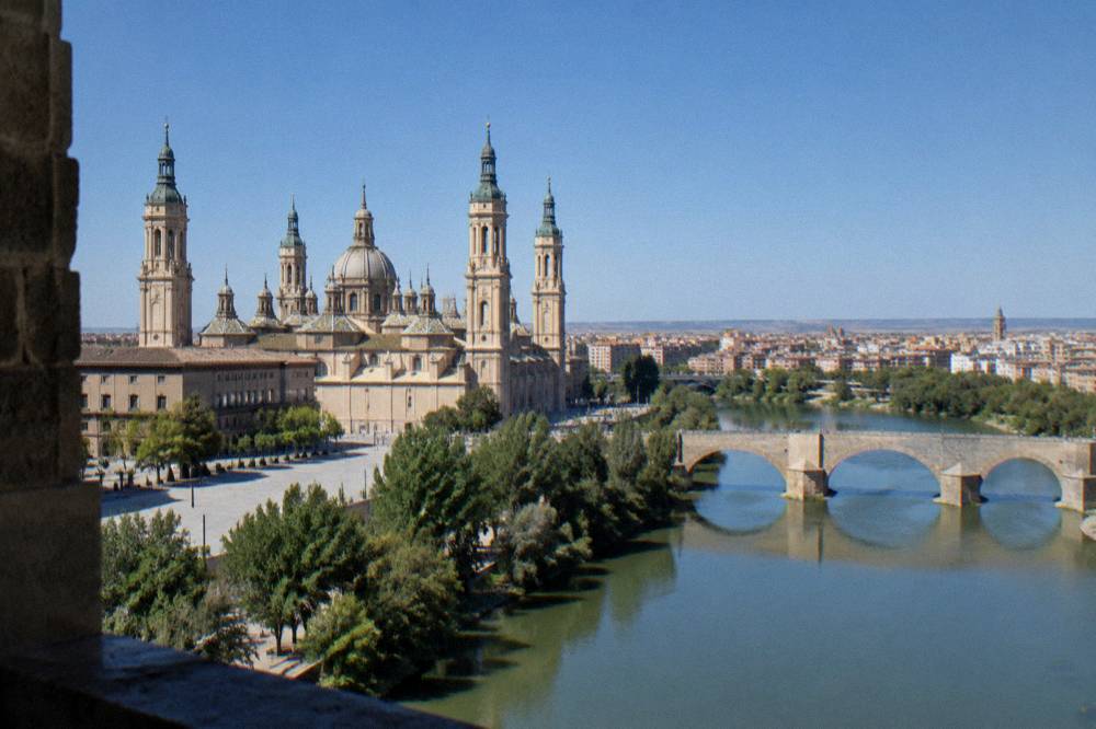 The view from the basilica tower over the Ebro river and the stone bridge with the city beyond