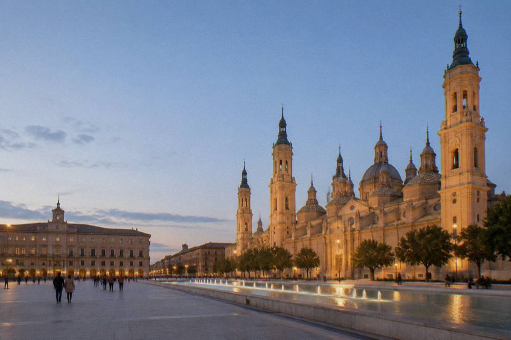 Evening light on the Plaza del Pilar with the basilica illuminated in Zaragoza