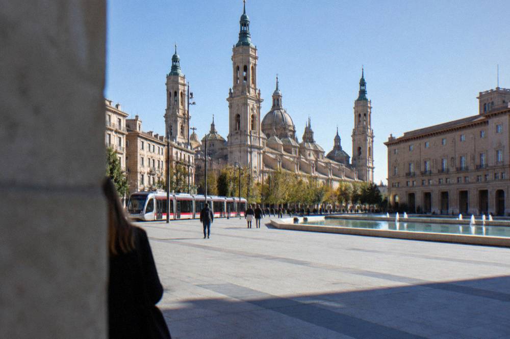 Zaragoza tram passing along a city street with old town buildings behind
