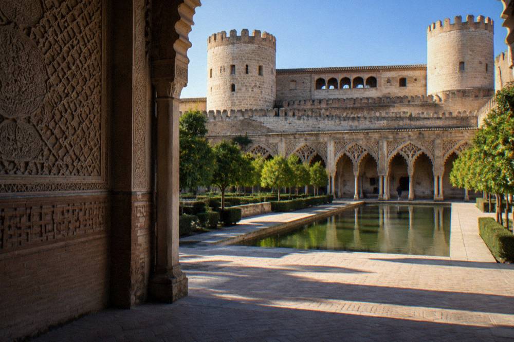 Carved plaster and geometric brick ornament on the walls of the Aljafería Palace in Zaragoza