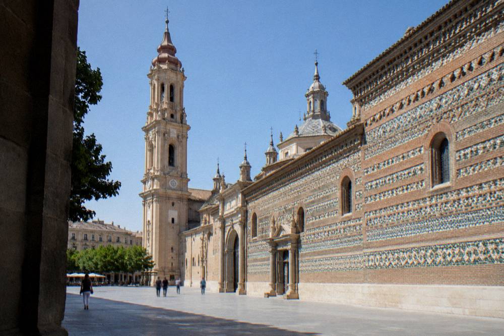 Glazed ceramic tiles set in geometric patterns on the Mudejar wall of La Seo in Zaragoza