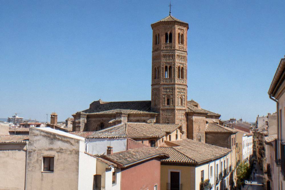The brick Mudejar tower of the church of San Pablo rising above rooftops in Zaragoza