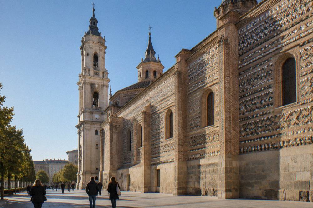Visitors walking past the ornate facade of La Seo cathedral in Zaragoza's old town