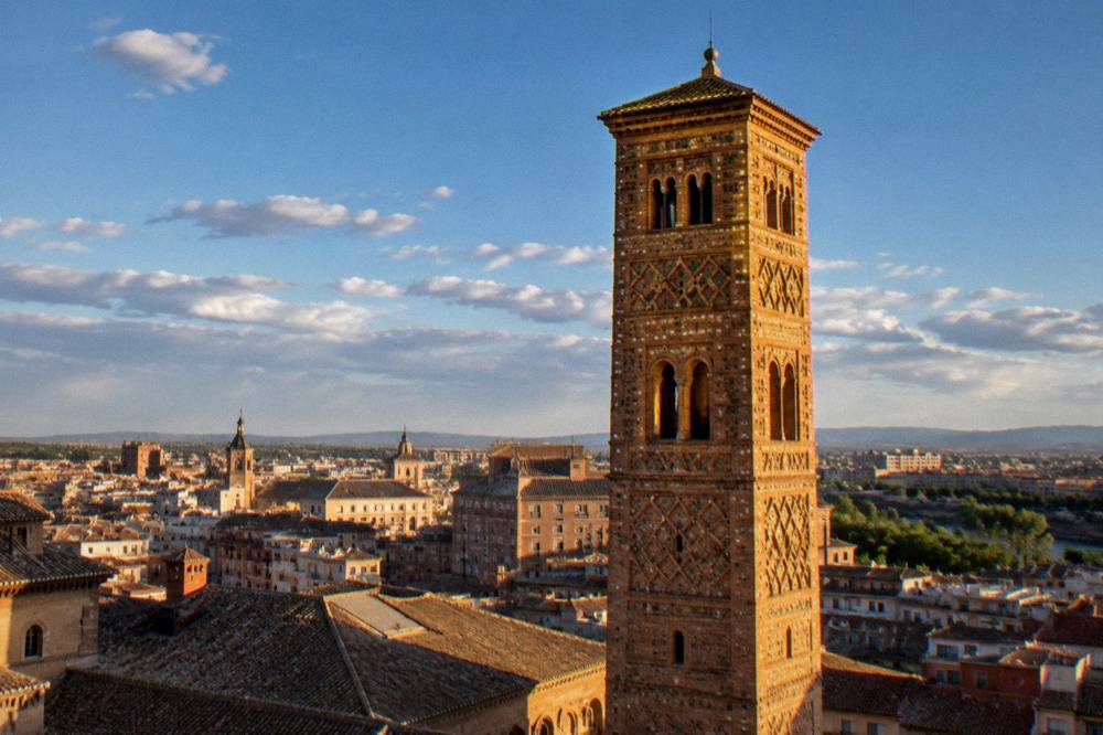 The glowing brickwork of a Mudejar tower at sunset in Zaragoza