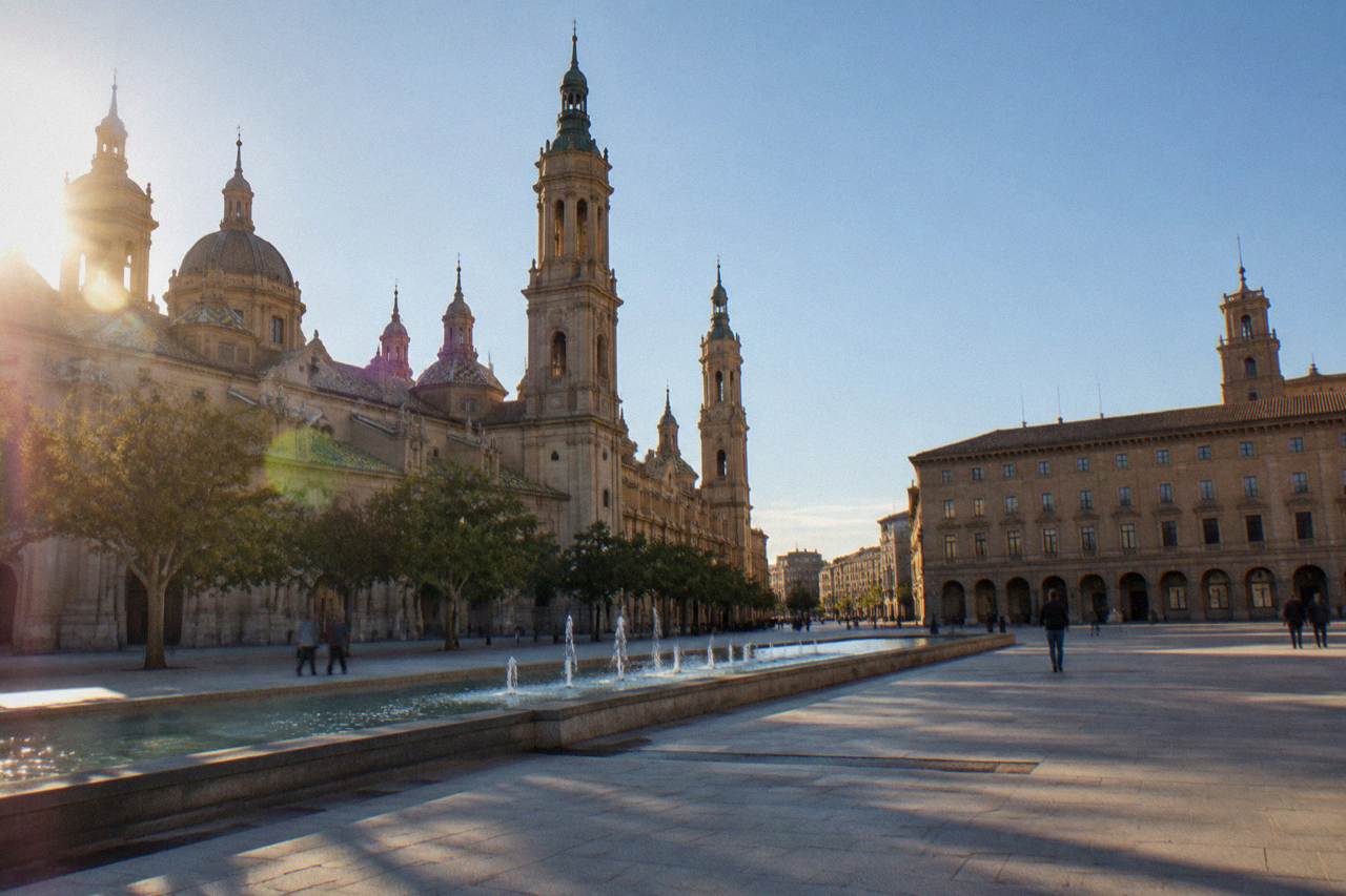 A restored museum interior in Zaragoza with polished stone floors and tall arched windows