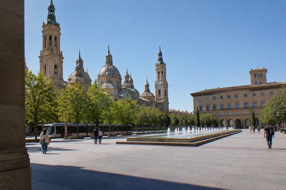 A tram passing along a tree-lined street in central Zaragoza
