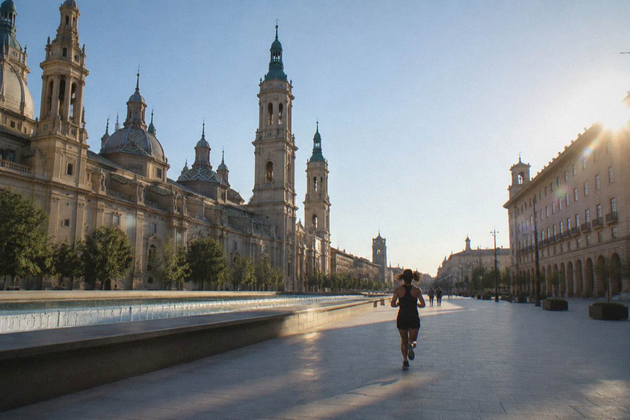 A stone museum facade on a quiet street in Zaragoza with carved sculptural decoration above the doorway