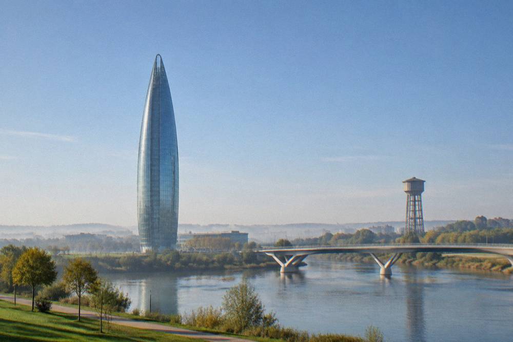 A tall lattice water tower rising above parkland and the Ebro river plain
