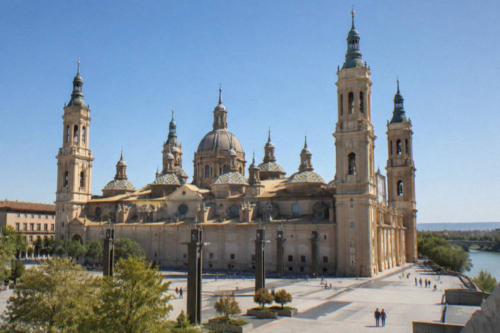 The baroque domes and towers of the Basilica del Pilar seen from the square below