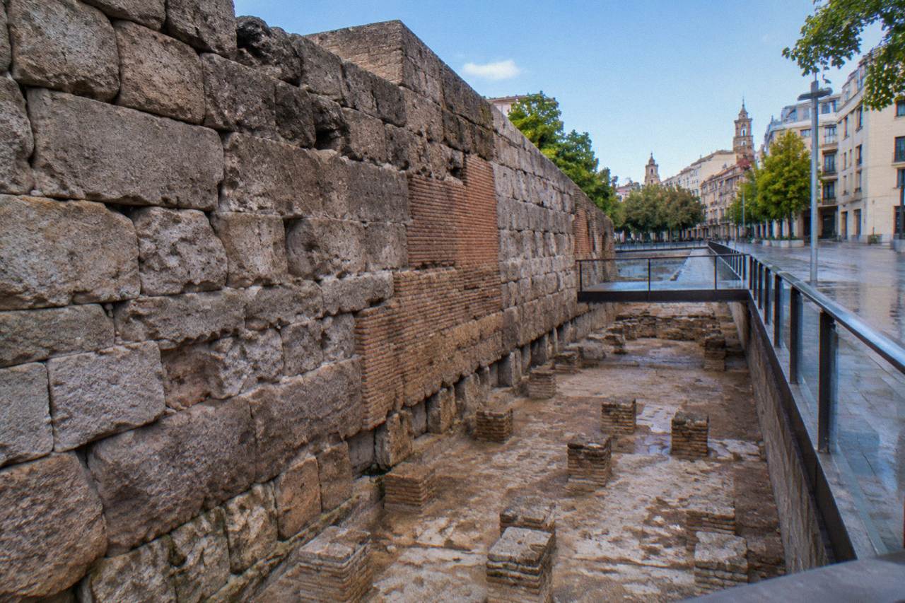 Ancient stone Roman bath remains displayed below street level in a museum in Zaragoza