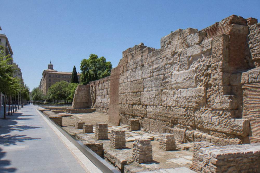 An exposed section of Roman wall stones built into a modern Zaragoza street scene