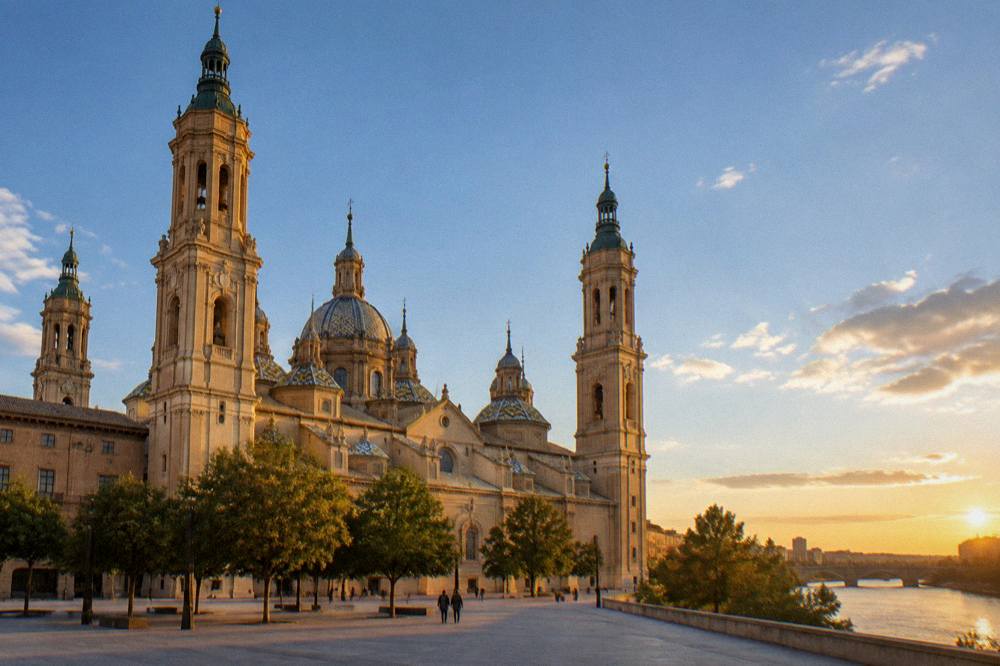 Sunset light over Zaragoza rooftops with the basilica towers and the Ebro in the distance