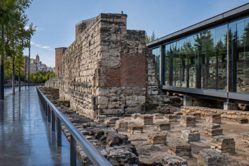 Excavated Roman wall foundations displayed beneath a modern glass museum structure