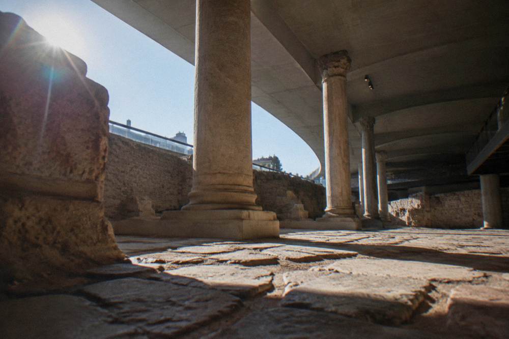 Ancient stone paving and wall fragments lit for display inside the Forum museum in Zaragoza