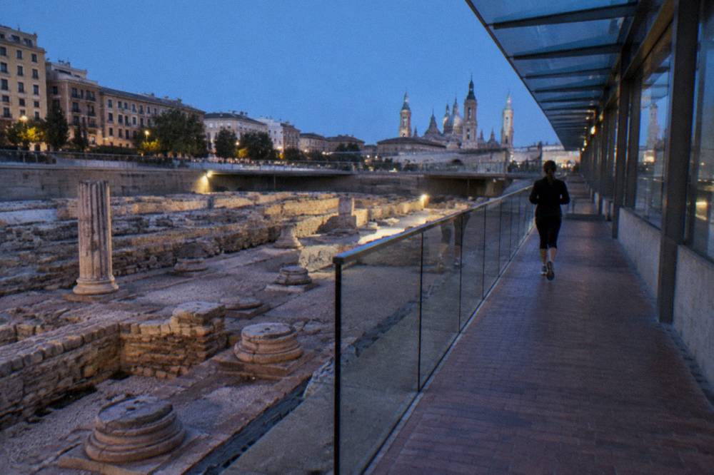 Museum corridor with glass panels overlooking Roman ruins in Zaragoza