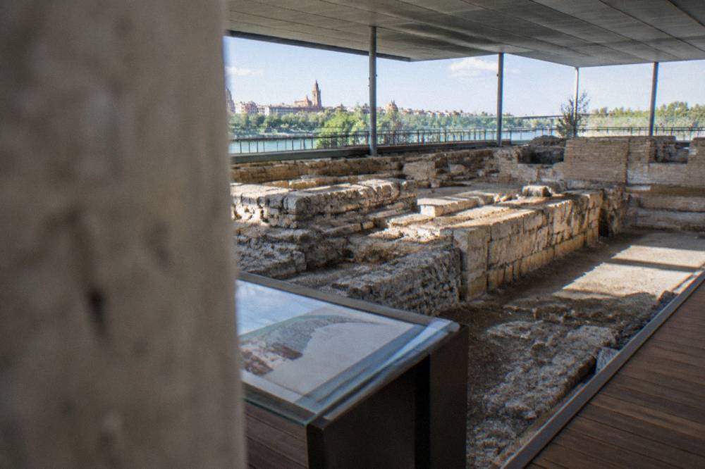 Museum information panel beside excavated Roman port remains under glass