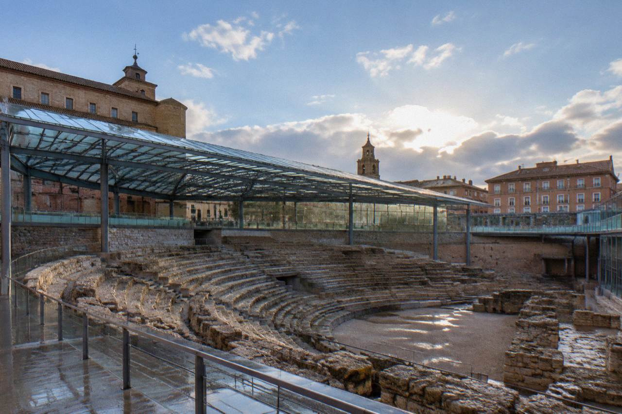 The excavated stone seating rows of the Roman theatre of Caesaraugusta seen from the museum walkway in Zaragoza