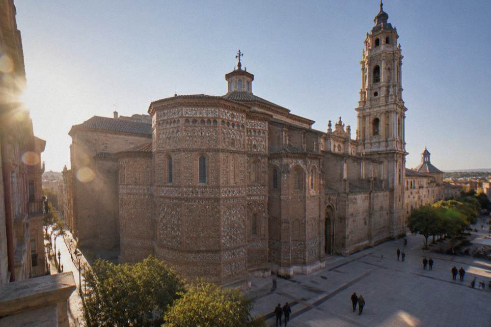 The Mudejar brick apse and cimborio of La Seo cathedral in Zaragoza seen from a square