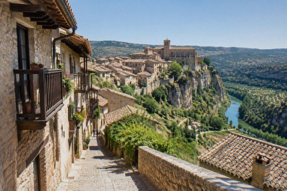 A narrow stone lane between old houses with wooden balconies in a hill village