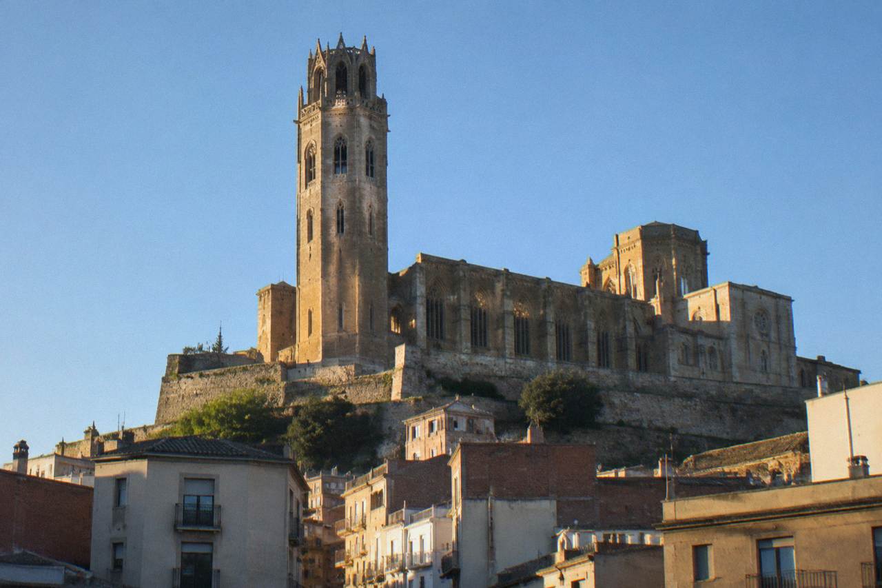 The hilltop old cathedral of Lleida rising above the city rooftops under a clear sky