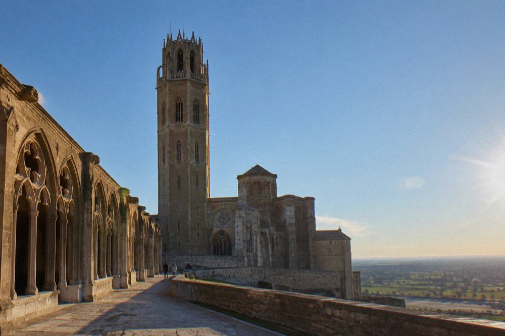 The Gothic cloister of the Seu Vella in Lleida with stone arches along the hilltop edge