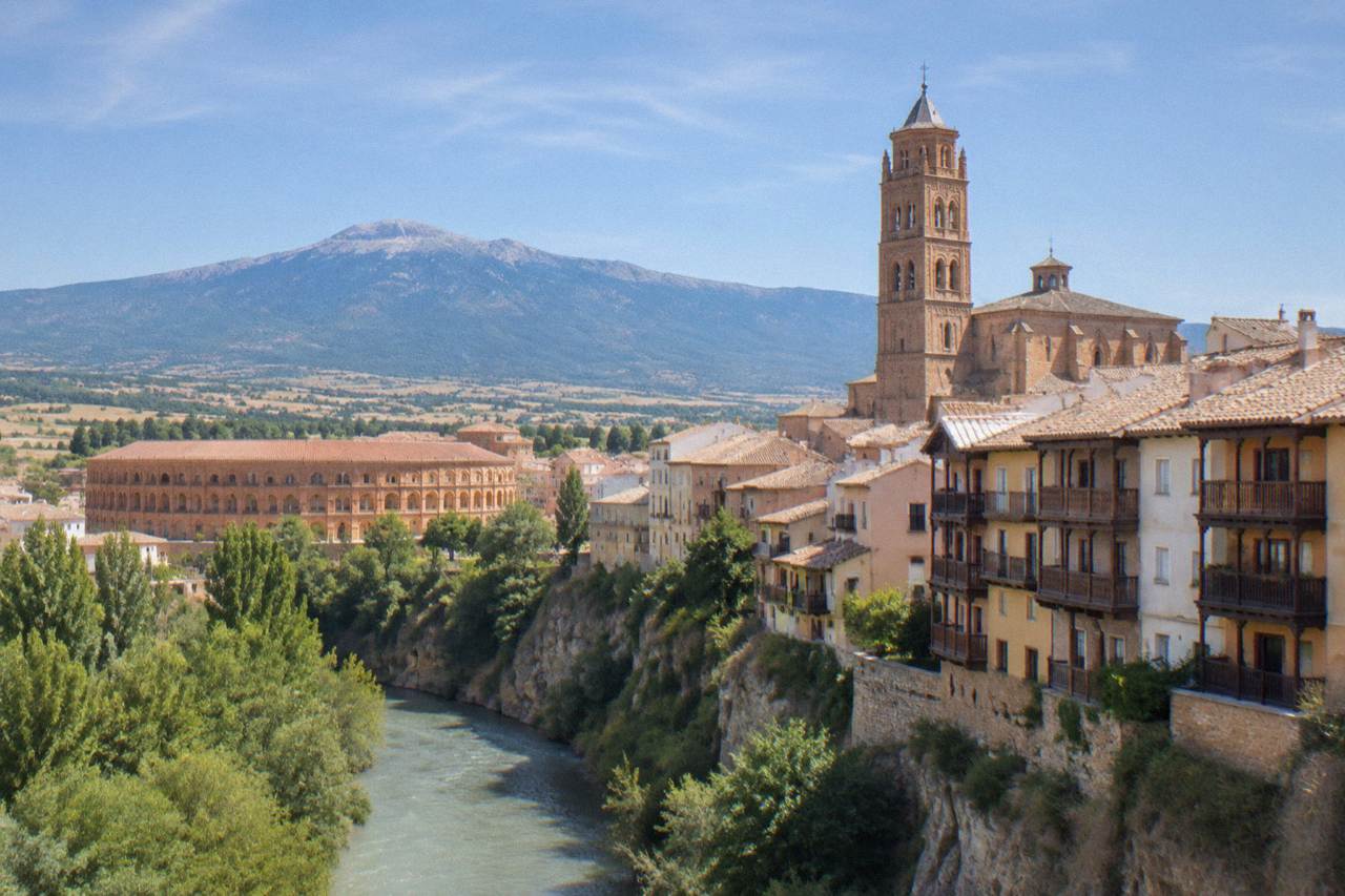 Forested mountain slopes of the Moncayo massif rising above rolling Aragon countryside