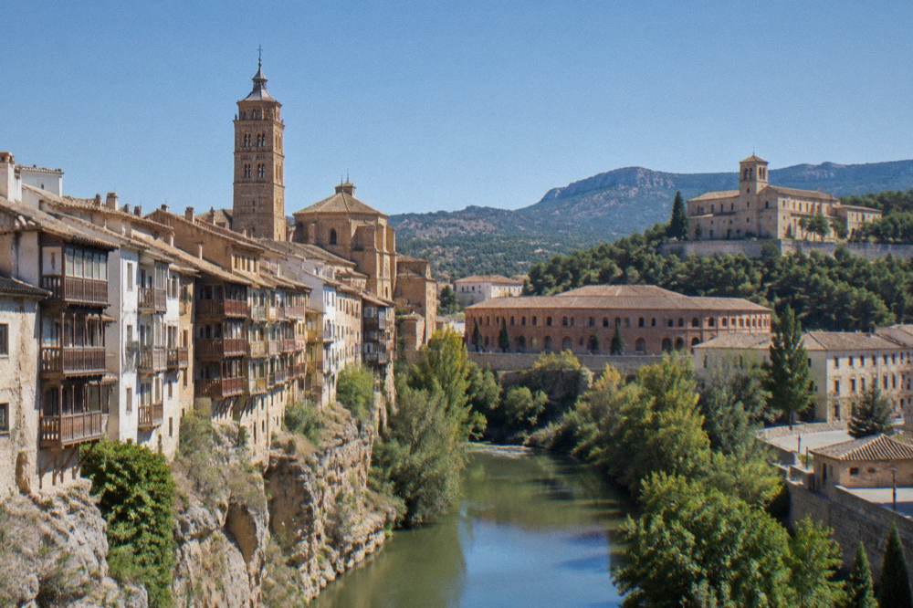 The stone walls and bell tower of the Monastery of Veruela among Moncayo woodlands