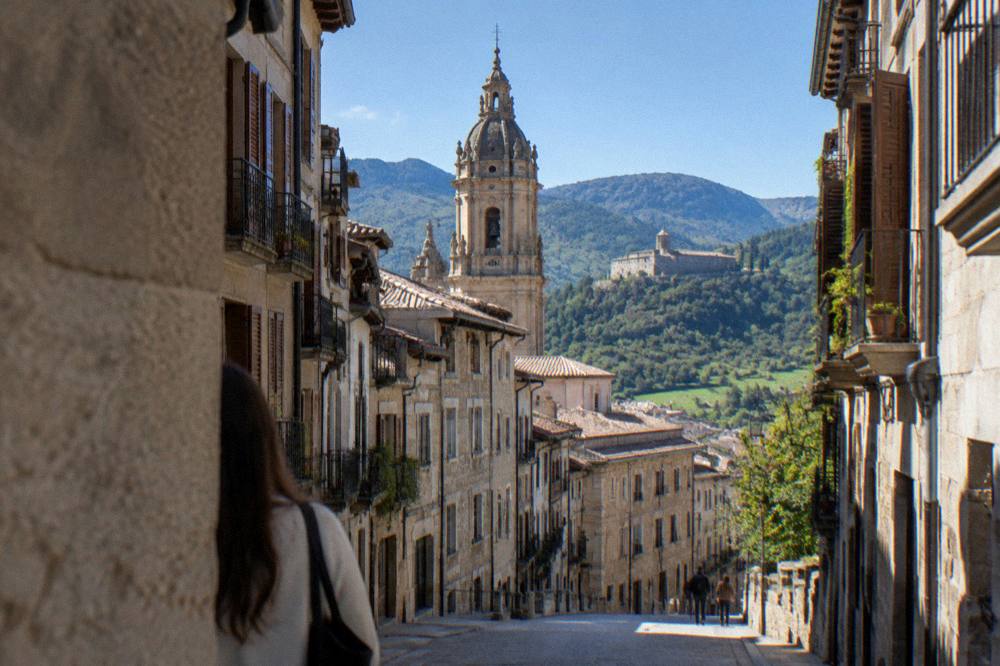 Green mountain slopes with a stone monastery in the Aragonese Pyrenees