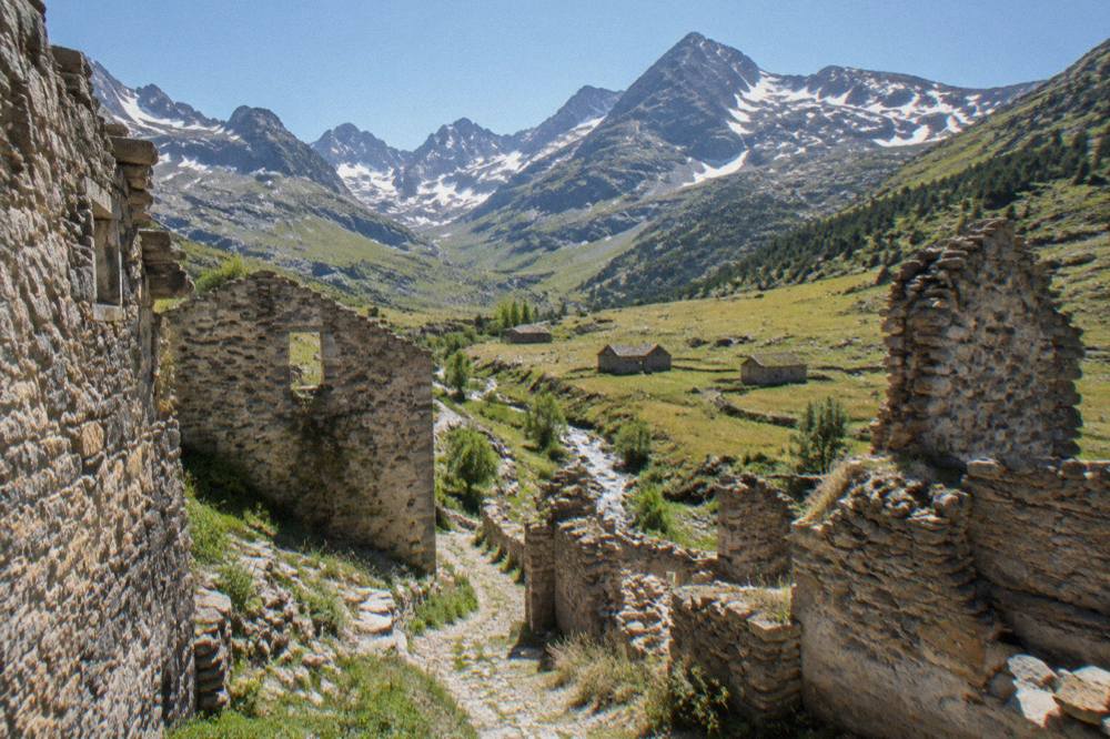 Old stone ruins of a village street standing open to the sky