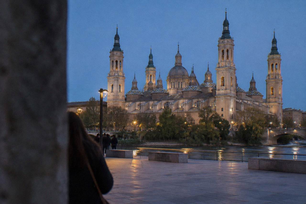 The Basílica del Pilar and its towers rising above the Ebro riverside at dusk in Zaragoza