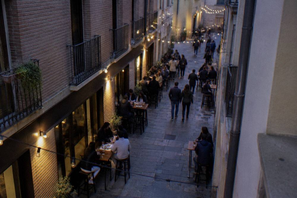 A narrow old-town street in Zaragoza lined with small tapas bars and brick facades