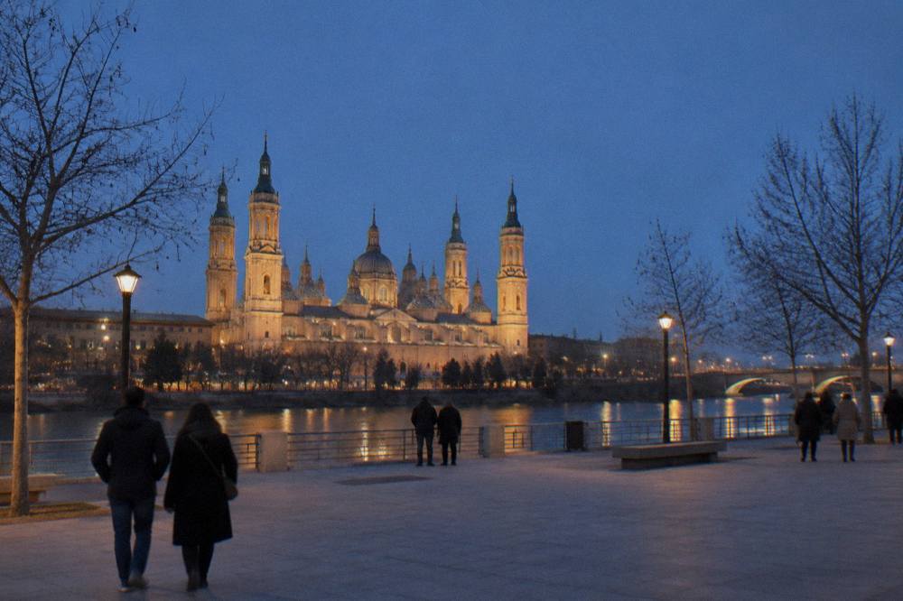 The Basílica del Pilar seen from across the Ebro at dusk, its domes lit against a dark winter sky