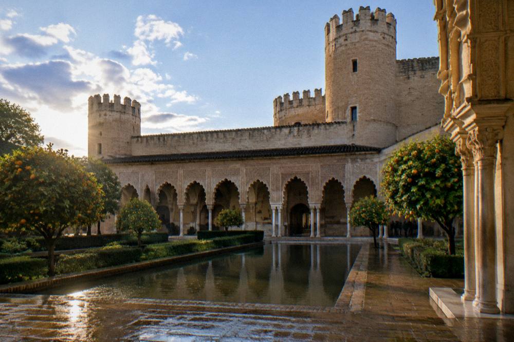 The ornate arches and carved stucco of the Aljaferia palace courtyard in Zaragoza