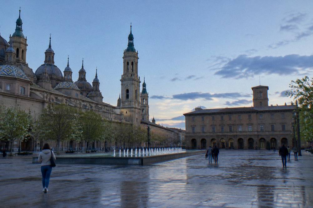 A quiet street of traditional brick buildings in the Zaragoza old town in spring light