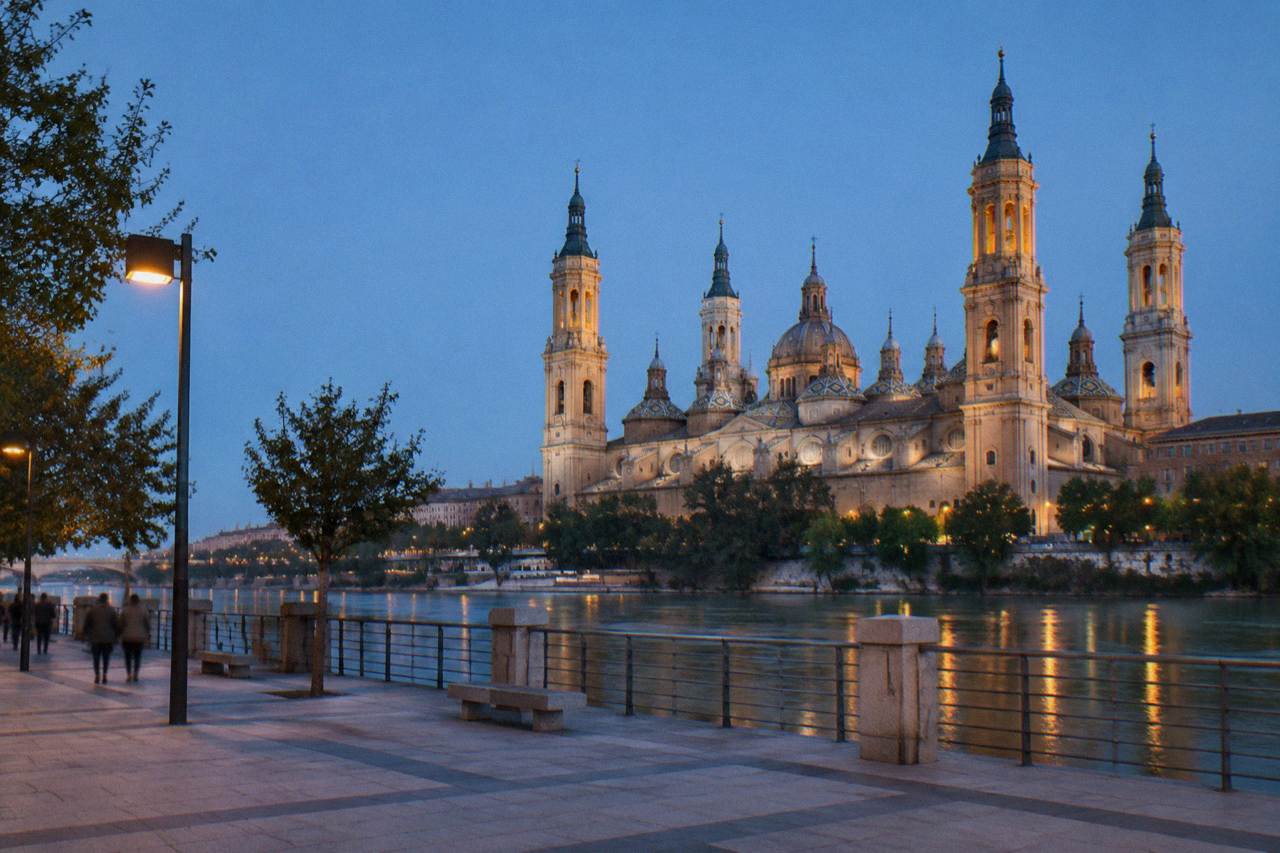 The Basílica del Pilar and its towers seen across the Ebro river at dusk in Zaragoza