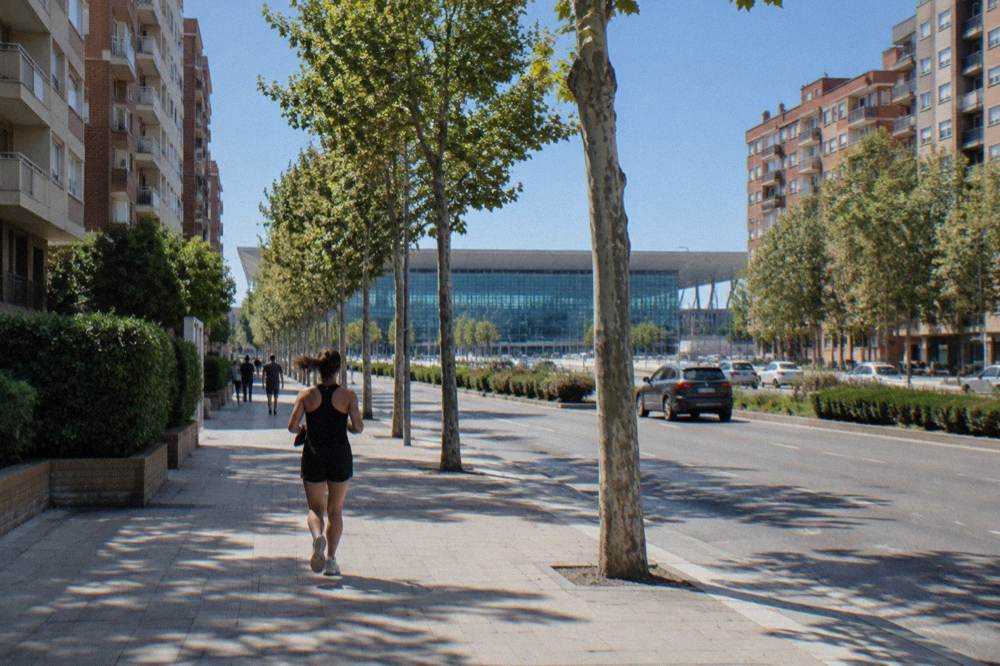 The modern glass facade of Zaragoza-Delicias railway station under a blue sky