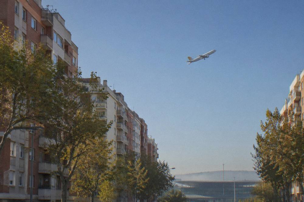 A low-cost airline plane climbing into the sky after takeoff from a regional airport