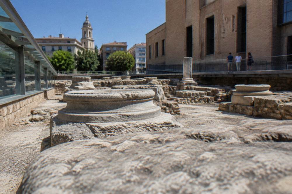 Visitors looking at Roman stone remains inside one of the Caesaraugusta museums in Zaragoza